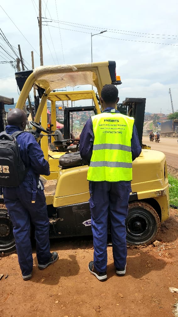 Forklift trainees carrying out pre-operation checks on the machine